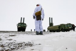 FILE - An officer stands near Bastion anti-ship missile systems on the Alexandra Land island near Nagurskoye, Russia, May 17, 2021.