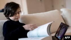 In this file photo taken on Nov. 21, 2019, Laurent Simons, 9 years old, poses during a photo session at his home in Amsterdam. 