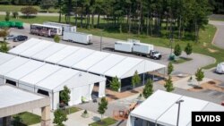 Contractors construct support structures at Fort Lee, Virginia, July 26, 2021, in preparation for the arrival of Afghan special immigrant applicants. (US Army photo)