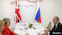 Russia's President Vladimir Putin and Britain's Prime Minister Theresa May attend a meeting on the sidelines of the G20 summit in Osaka, Japan June 28, 2019.