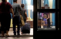 FILE - Immigrants seeking asylum who were recently reunited arrive at a hotel, in San Antonio, July 23, 2018.