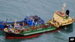 북한 선적 유조선 '유정 2호(아래)'와 국적을 알 수 없는 '민닝더유 078 호'가 지난 16일 동중국해상에서 호스를 연결한 채 떠 있는 사진을 일본 방위성이 공개했다. 방위성은 북한의 유엔 제재결의 위반이 매우 의심된다고 지적했다.