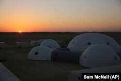 The sun rises over a 2.4-ton inflated structure used by the AMADEE-18 Mars simulation in the Dhofar desert of southern Oman.