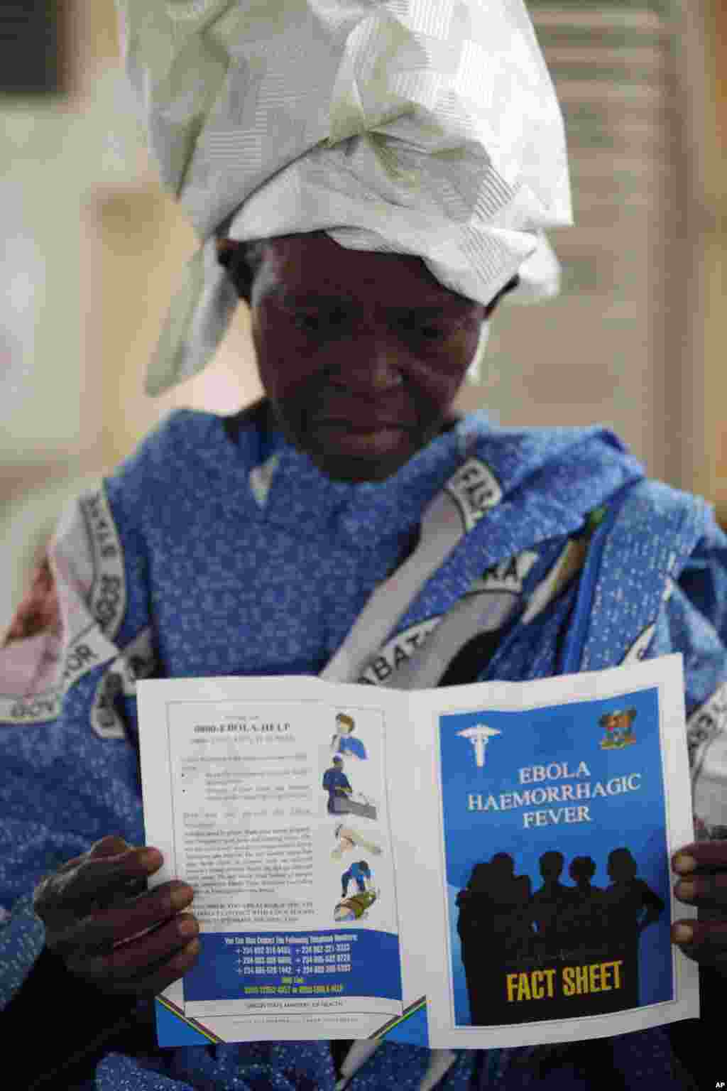 A woman reads a fact sheet for the Ebola virus during an awareness campaign in Lagos, Nigeria, Aug. 15, 2014.&nbsp;
