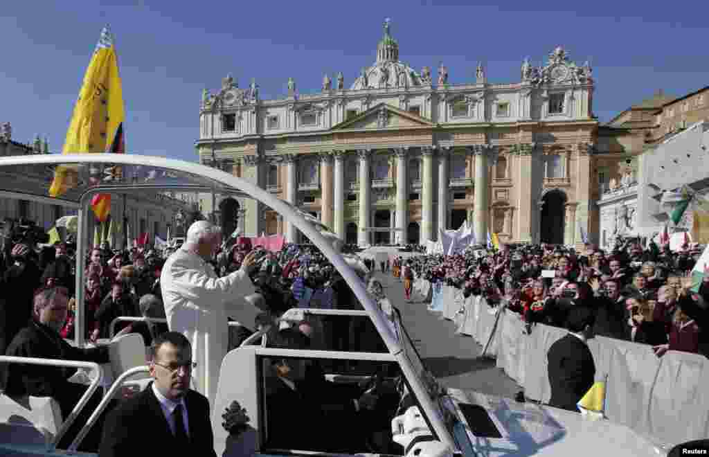 Pope Benedict waves to the faithful after arriving in St. Peter&#39;s Square to hold his last general audience at the Vatican, Feb. 27, 2013.