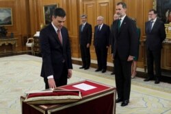 FILE - Spain's Prime Minister and Socialist party leader Pedro Sanchez is sworn in next to King Felipe during a ceremony at the Zarzuela Palace in Madrid, June 2, 2018.