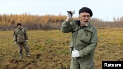 Sergey Zimov, 66, a scientist who works at Russia's Northeast Science Station, checks for permafrost at the Pleistocene Park outside the town of Chersky, Sakha (Yakutia) Republic, Russia, September 13, 2021. (REUTERS/Maxim Shemetov)