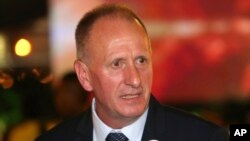 FILE- British cave expert Vernon Unsworth talks with guests at an event titled the "United as One" in Bangkok, Thailand, Sept. 6, 2018. 