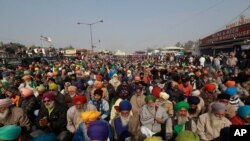 Protesting farmers listen to a speaker at the Delhi- Haryana border, outskirts of New Delhi, India, Dec. 17, 2020.