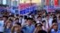 Tens of thousands of North Koreans rally at Kim Il Sung Square carrying placards and propaganda slogans as a show of support for their rejection of the United Nations' latest round of sanctions, in Pyongyang, North Korea, Aug. 9, 2017.