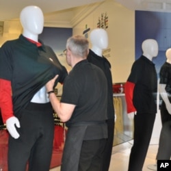 Hudson's Bay company store employee Brian McLelland rearranges a black t-shirt on a display figure