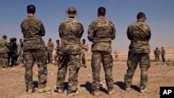 In this 2013 photo, US special operations forces watch forces from Iraq, Jordan, and Lebanon during a multinational military exercise in Zarqa, Jordan. The government-owned Al-Rai newspaper said Monday a Jordanian policeman opened fire on American 