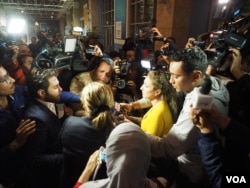 Media interviews an Egyptair host who has just arrived from the hijacked flight at Cairo airport, Tuesday, March 28, 2016. (H. Elrasam/VOA)