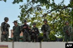 Soldiers are seen at a military headquarter as opposition supporters (not pictured) give out copies of amnesty measures to anyone in the military who disavows President Nicolas Maduro, in Caracas, Venezuela, Jan. 27, 2019.