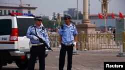 Armed police stand guard at Tiananmen Square in Beijing, June 4, 2014.