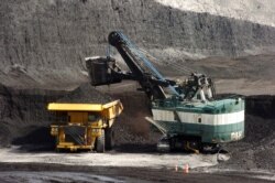 FILE - In this April 4, 2013, file photo, a mechanized shovel loads a haul truck with coal at the Spring Creek coal mine near Decker, Mont.