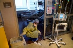 Seorang perawat ICU, memindahkan kabel listrik untuk mesin medis, di luar kamar pasien COVID-19, di unit perawatan intensif Willis-Knighton Medical Center di Shreveport, Louisiana, 17 Agustus 2021..