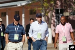 U.S. Ambassador to Myanmar Derek Mitchell, center, an observer of Myanmar elections, walks from a polling station in Mandalay, Myanmar, Nov. 8, 2015.