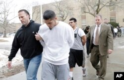 FILE - Suspected members of the MS-13 gang are escorted to their arraignment in Mineola, N.Y., Jan. 11, 2018.