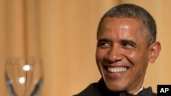 President Barack Obama laughs as actor and comedian Joel McHale speaks during the White House Correspondents' Association Dinner at the Washington Hilton Hotel, May 3, 2014, in Washington.