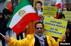 An opponent of Iranian President Hassan Rouhani chants slogans during a protest outside the European Union Council in Brussels, Belgium, Jan. 3, 2018.
