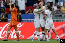United States' Rose Lavelle, second right, celebrates with Megan Rapinoe, center, after scoring her side's second goal during the Women's World Cup final soccer match between US and The Netherlands at the Stade de Lyon in Decines