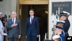 Secretary of Defense Jim Mattis, left, and U.K. Secretary of State for Defense Gavin Williamson stand for the National Anthem during an arrival ceremony prior to their meeting at the Pentagon, Aug. 7, 2018. 