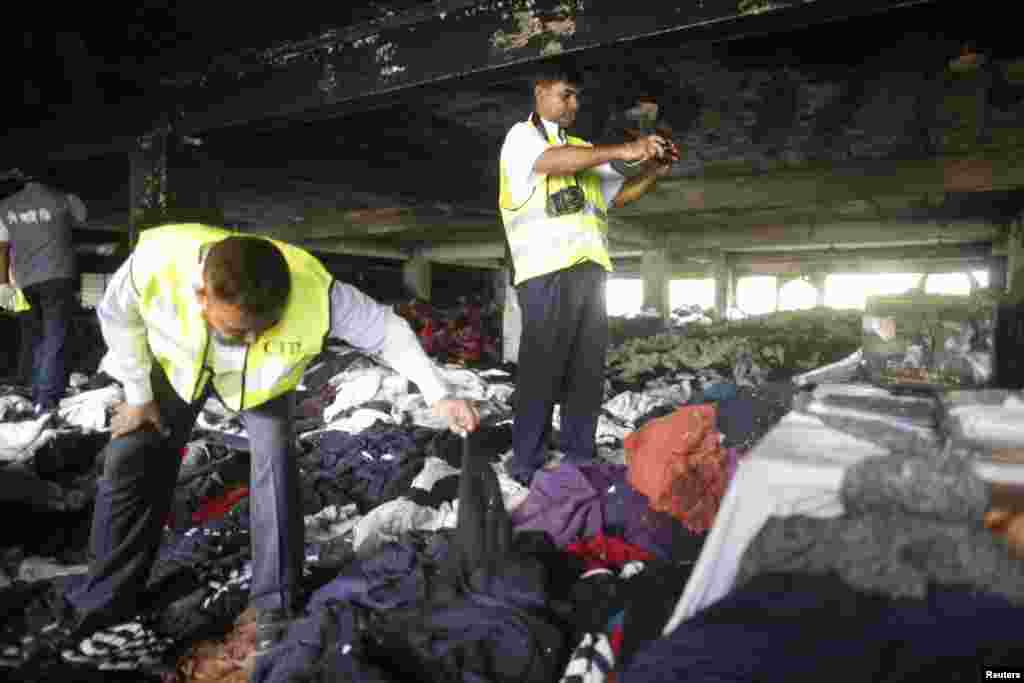 Members of the Criminal Investigation Department inspect a factory after a deadly fire occurred, Dhaka, Bangladesh, May 9, 2013. 