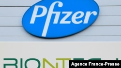 FILE - Combination of file photographs with the logo of Pfizer at the production site of the COVID-19 vaccine in Puurs, Belgium, and a logo of BioNTech at the headquarters of the company in Mainz, western Germany.