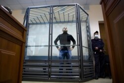 Andrei Pivovarov, the head of Open Russia movement stands behind the glass during a court session in Krasnodar, Russia, June 2, 2021.