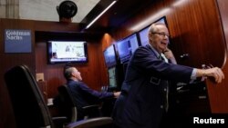 FILE - Traders work inside the Goldman Sachs booth on the floor of the New York Stock Exchange (NYSE) in New York, U.S., September 21, 2018. (REUTERS/Brendan McDermid)