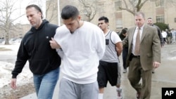 FILE - Suspected members of the MS-13 gang are escorted to their arraignment in Mineola, N.Y., Jan. 11, 2018. 