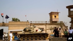 FFILE - Egyptian security forces stand guard outside one of the entrances of Tora prison, in Cairo, Egypt.