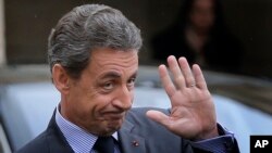FILE - Nicolas Sarkozy, former French president and head of the conservative "Les Republicains" party, is seen leaving after a meeting with French President Francois Hollande at the Elysee Palace, in Paris, Jan. 22, 2016.