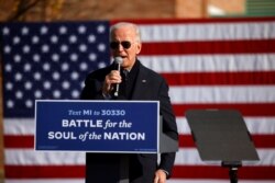 Democratic presidential nominee Joe Biden speaks at a campaign drive-in mobilization event in Flint, Mich., Oct. 31, 2020.