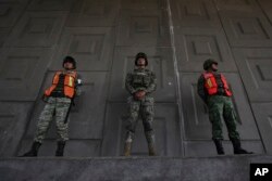 Soldiers stand guard to watch for passing migrants riding in public transportation in Tapachula, Chiapas state, Mexico, June 9, 2019.