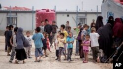 FILE - Women and children gather at al-Hol camp, which houses some 60,000 refugees, including families and supporters of Islamic State, in Hasakeh, Syria, May 1, 2021. The U.S. State Department said on May 7, 2024, that it had repatriated 11 U.S. citizens from Syrian camps.