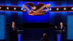 President Donald Trump, left, and Democratic presidential candidate former Vice President Joe Biden, right, with moderator Chris Wallace, center, of Fox News during the first presidential debate Tuesday, Sept. 29, 2020, at Case Western University…