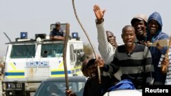 Miners take part in a march outside the Anglo American mine in South Africa's North West Province, Sept. 12, 2012.