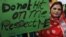 FILE - Pakistani woman holds a sign as she observes the International Day for the Elimination of Violence against Women, in Lahore, Pakistan, Nov. 25, 2015. 