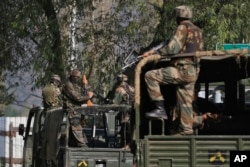 FILE - Indian soldiers guard outside the army base which was attacked by suspected militants at Uri, Indian-controlled Kashmir, Sept. 19, 2016.