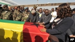 Guinea-Bissau's interim President Raimundo Pereira (C) touches on January 14, 2012 the coffin of late President Malam Bacai Sanha, who died in on January 9, 2012 at a Paris hospital, upon its return to Bissau.