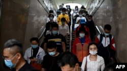 This June 2, 2021 file photo shows rush hour in Beijing. China's youth are "lying flat", the latest expression for those who are unhappy with the culture of long working hours, high housing prices, and a very high cost of living.