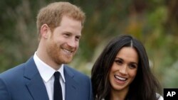 FILE - Britain's Prince Harry and his fiancee Meghan Markle pose for photographers on the grounds of Kensington Palace in London, Monday Nov. 27, 2017 to announce their engagement. (AP Photo/Matt Dunham)