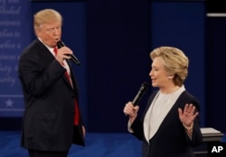 Republican presidential nominee Donald Trump and Democratic presidential nominee Hillary Clinton speak during the second presidential debate at Washington University in St. Louis, Oct. 9, 2016.