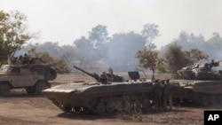 FILE - In this photo made available by the Nigerian Military taken Tuesday, April 28, 2015, Nigerian military personnel in action during an attack on Islamic extremists in the Sambisa Forest, Nigeria. 