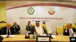 Arab League Secretary General, Nabil Elarabi, left, Qatari Prime Minister Sheikh Hamad bin Jassim bin Jabr al-Thani, center, and Ahmed bin Heli, the Arab League's assistant secretary-general for political affairs, during the group's meeting on Syria held 