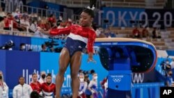 Simone Biles, of the United States, lands from the vault during the artistic gymnastics women's final at the 2020 Summer Olympics, Tuesday, July 27, 2021, in Tokyo. (AP Photo/Gregory Bull)