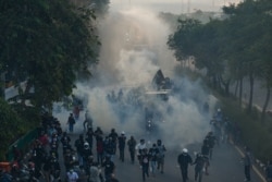 Police use a water cannon and tear gas to disperse protesters taking part in a demonstration calling for the resignation of Thailand's Prime Minister Prayut Chan-ocha.