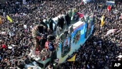 A woman holds a picture of Iranian Major-General Qassem Soleimani, who was killed in a airstrike near Baghdad, during a condolence ceremony outside the Embassy of Iran in Kuala Lumpur, Malaysia, January 7, 2020.